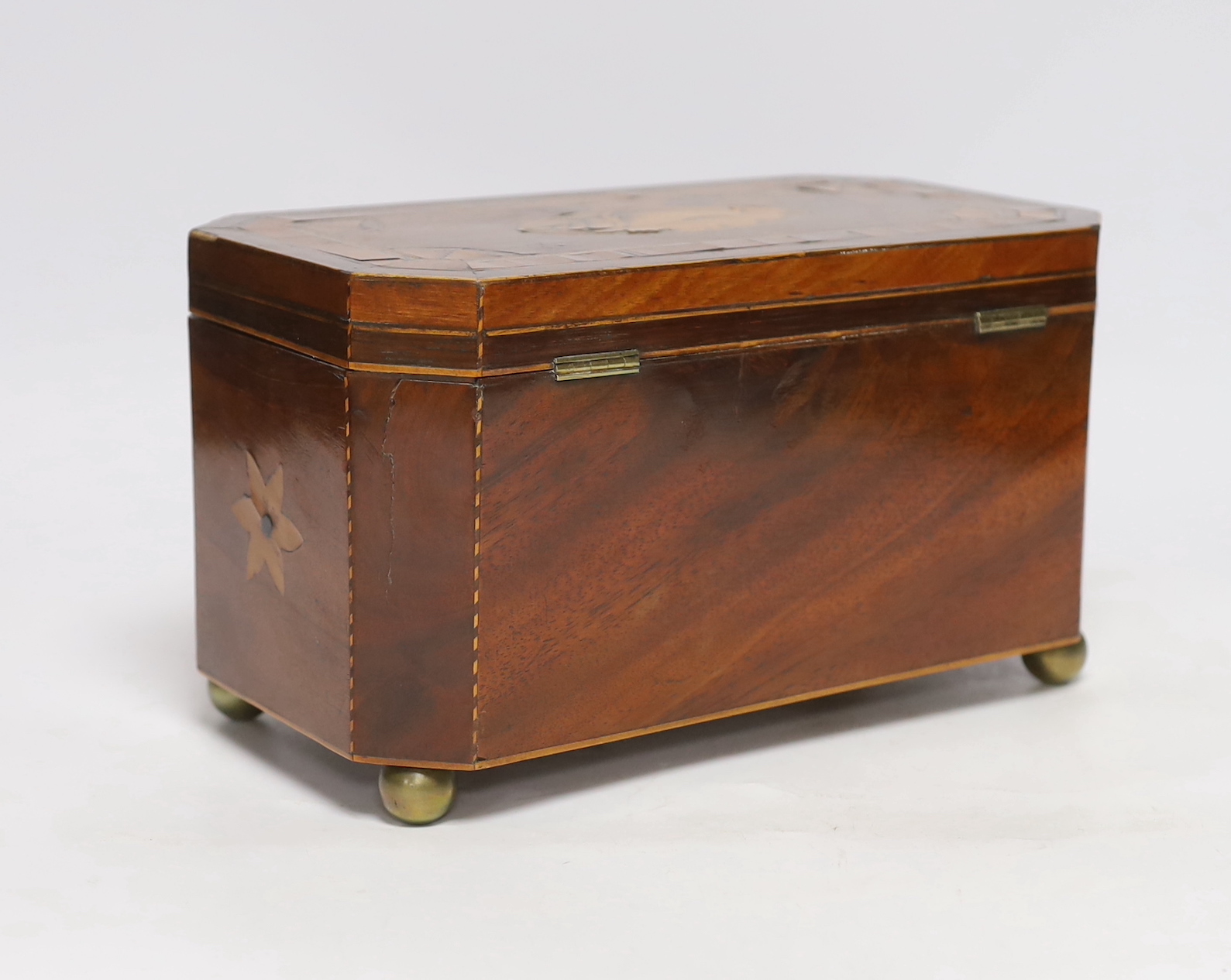 An early 19th century shell inlaid cross banded mahogany tea caddy, 26cm wide